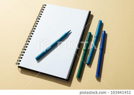 Close up of notebook and four markers with copy space on yellow background Close up of notebook and four markers with copy space on yellow background 103941452