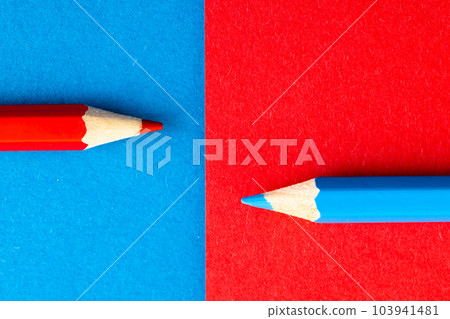 Close up of red and blue pencils with copy space on red and blue background Close up of red and blue pencils with copy space on red and blue background 103941481