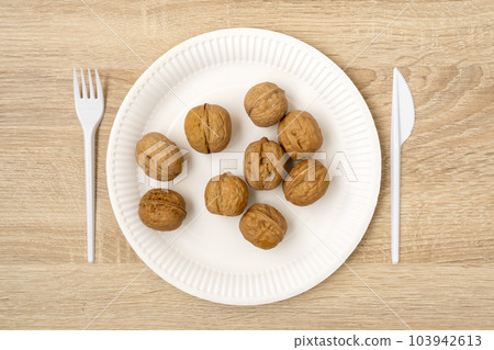 Walnuts in a white disposable plate Walnuts in a white disposable plate 103942613