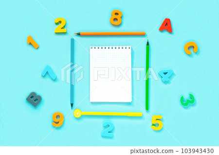 School supplies on blue background. Different stationery and letters with blank space. View from above, flat lay with space for text. Colorful Back to School concept. Elementary school. Empty notepad School supplies on blue background. Different stationery and letters with blank space. View from above, flat lay with space for text. Colorful Back to School concept. Elementary school. Empty notepad 103943430