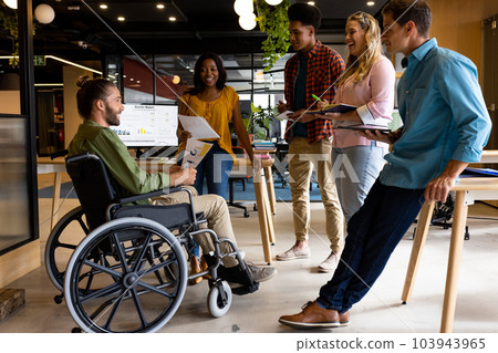 Diverse male and female colleagues in discussion at casual office meeting Diverse male and female colleagues in discussion at casual office meeting 103943965