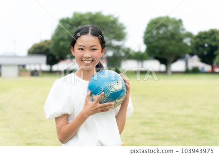 smiling girl with soccer ball 103943975