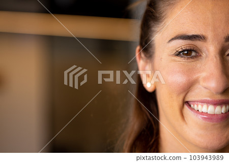 Half portrait of happy caucasian casual businesswoman with brown eyes smiling, with copy space 103943989