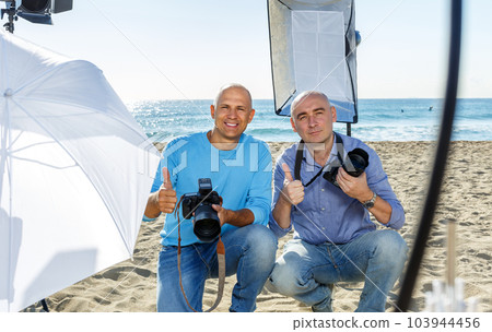 Portrait of two photographers on seaside Portrait of two photographers on seaside 103944456