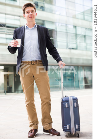 Smiling man worker going with baggage 103944611