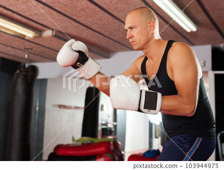 Potrait of man boxer who is training in gym 103944975
