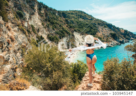 Happy woman enjoying the view of summer beach 103945147