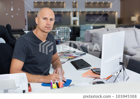 Sales consultant working with computer in furniture shop Sales consultant working with computer in furniture shop 103945308