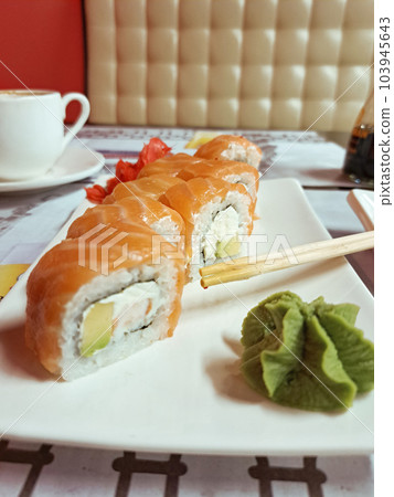 Sushi with salmon and wasabi on a white plate. Japanese and Chinese food Sushi with salmon and wasabi on a white plate. Japanese and Chinese food 103945643