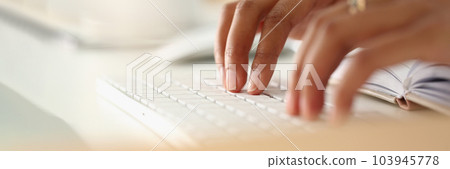 Closeup of African female hands typing on keyboard Closeup of African female hands typing on keyboard 103945778