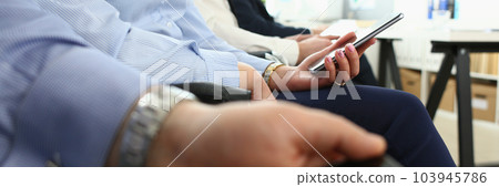 Business people sit in row at business conference Business people sit in row at business conference 103945786