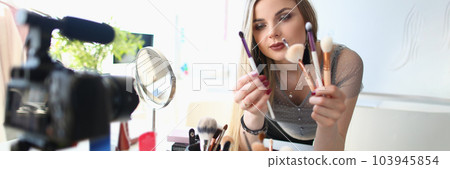 Beauty blogger shoots daily women makeup routine videos on camera Beauty blogger shoots daily women makeup routine videos on camera 103945854