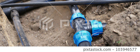 Connecting water supply closeup on background of earth 103946577