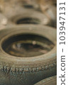 Old, worn-out tires background. Theme of decay and recycling. Industrial, urban backdrop with copy space. Sign of rust, cracking. 103947131