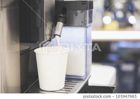 Cappuccino is poured into a white paper cup, take your coffee with you 103947663