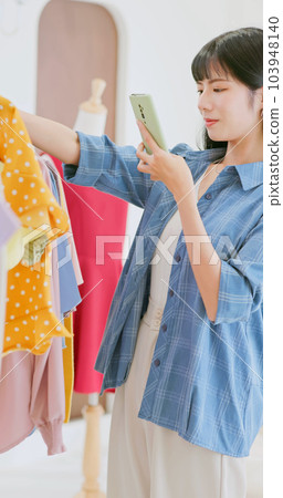 asia female choose clothes boutique 103948140