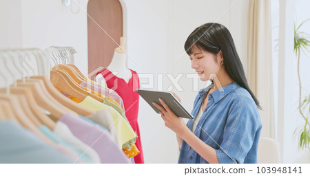 asia clerk checking clothes stock 103948141