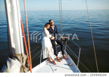 Beautiful wedding couple on yacht at wedding day outdoors in the sea. Together. Wedding day. 103949204