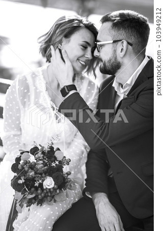 Beautiful black and white photo of bride and groom. Happy couple posing and smiling in wedding dress 103949212