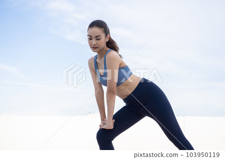 Young beauty Asian woman stretching workout outdoor rooftop. She warming up Young beauty Asian woman stretching workout outdoor rooftop. She warming up 103950119