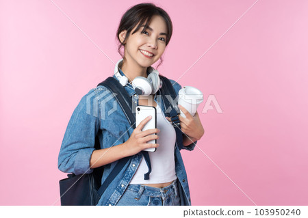 Portrait of young Asian woman student standing with smartphone coffee and backpack.College Teenager University concept. Portrait of young Asian woman student standing with smartphone coffee and backpack.College Teenager University concept. 103950240