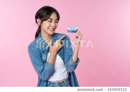 Young Asian woman showing blank credit card in formal suit, isolated pink background Young Asian woman showing blank credit card in formal suit, isolated pink background 103950332