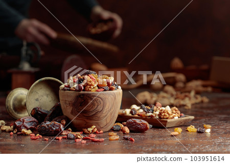 Various dried fruits and nuts on a kitchen table. 103951614