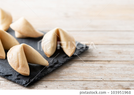 Traditional fortune cookies on wooden table Traditional fortune cookies on wooden table 103951968