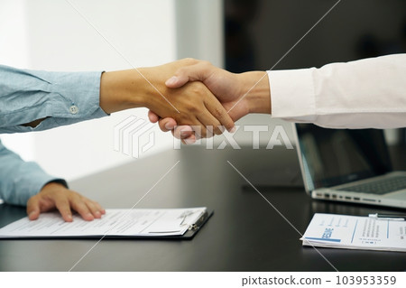 Businessman shaking hands successful candidate at interview. got the job in the team. Welcome aboard successful making a deal..partnership meeting concept. Businessman shaking hands successful candidate at interview. got the job in the team. Welcome aboard successful making a deal..partnership meeting concept. 103953359