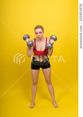 Smiling young plump fitness sporty seductive woman working out doing exercise with dumbbells 103953976