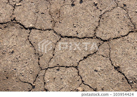 Crack. Dry soil. The global shortage of water on the planet. Global warming and greenhouse effect concept. The parched soil. Baraje. Soil drought cracked texture. Crack. Dry soil. The global shortage of water on the planet. Global warming and greenhouse effect concept. The parched soil. Baraje. Soil drought cracked texture. 103954424