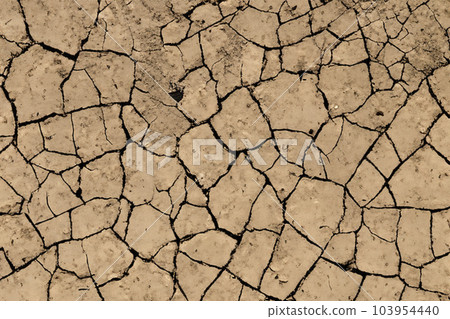 Crack. Dry soil. The global shortage of water on the planet. Global warming and greenhouse effect concept. The parched soil. Baraje. Soil drought cracked texture. 103954440