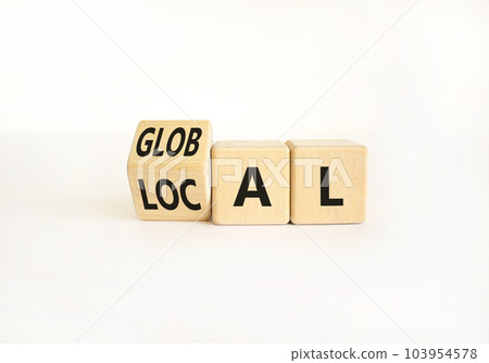 Local or global symbol. Businessman turns wooden cubes and changes the word Local to Global. Beautiful white table white background. Business and local or global concept. Copy space. 103954578
