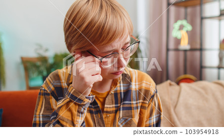 Upset disappointed young woman wipes tears and cries from despair, unrequited love, problems at home 103954918