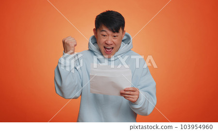 Asian man open envelope letter, great news, celebrate, monetary award, invitation, bank loan approve 103954960