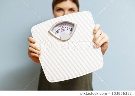 Beautiful young woman with white scales on the blue background 103956332