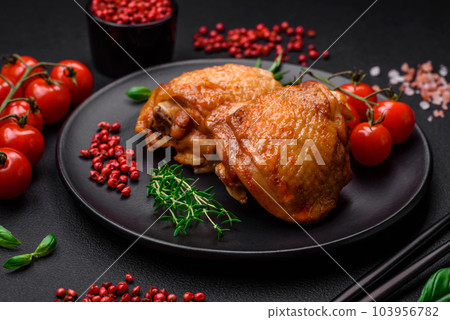 Delicious juicy chicken thighs baked with salt, spices and herbs in a ceramic plate Delicious juicy chicken thighs baked with salt, spices and herbs in a ceramic plate 103956782