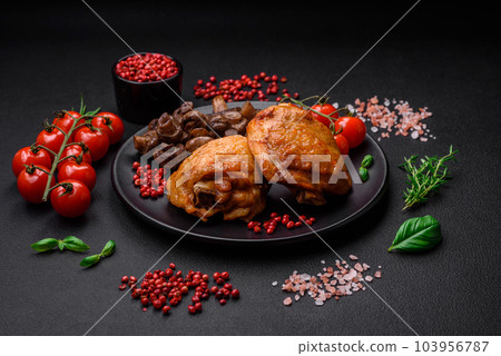 Delicious juicy chicken thighs baked with salt, spices and herbs in a ceramic plate Delicious juicy chicken thighs baked with salt, spices and herbs in a ceramic plate 103956787