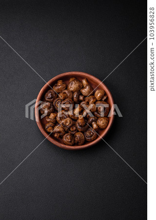 Delicious champignon mushrooms with salt, spices and herbs Delicious champignon mushrooms with salt, spices and herbs 103956828