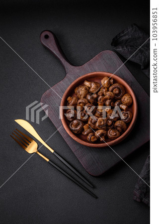 Delicious champignon mushrooms with salt, spices and herbs 103956851