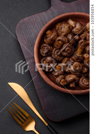 Delicious champignon mushrooms with salt, spices and herbs Delicious champignon mushrooms with salt, spices and herbs 103956854