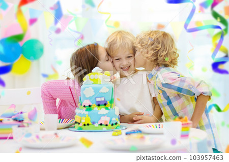 Kids birthday party. Child blowing out cake candle Kids birthday party. Child blowing out cake candle 103957463