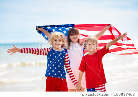 Kids with American flag on beach. 4th of July. 103957468