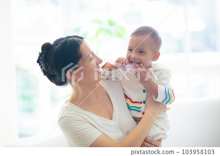 Baby and mother at home. Mom and child. Baby and mother at home. Mom and child. 103958103