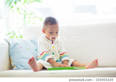 Baby boy reading a book. Kids read. 103958104