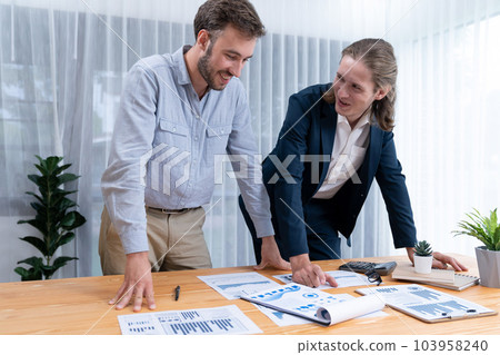 Analyst team in office analyzing financial data analysis papers. Entity 103958240