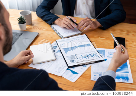 Busy analyst team in office analyzing financial data analysis. Entity Busy analyst team in office analyzing financial data analysis. Entity 103958244
