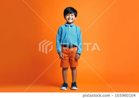 Asian kid on orange studio background, cute smiling child portrait, generative AI. 103960104