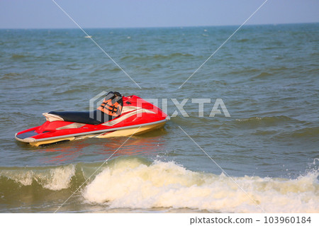 Jet ski stand by on the beach for support traveler. extreme sport on the sea or the beach and high speed. The jet ski should be driven by professional because so fast and dangerous. 103960184