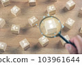 Selection concept. Human Resource Manager chooses new person to join an organization or support a cause. Magnifying glass zooms a cube that is best person. 103961644